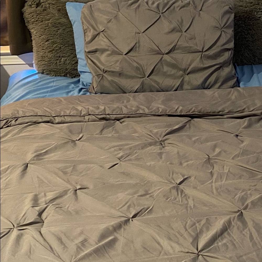 A gray pleated comforter set with two blue twin xl sheet sets